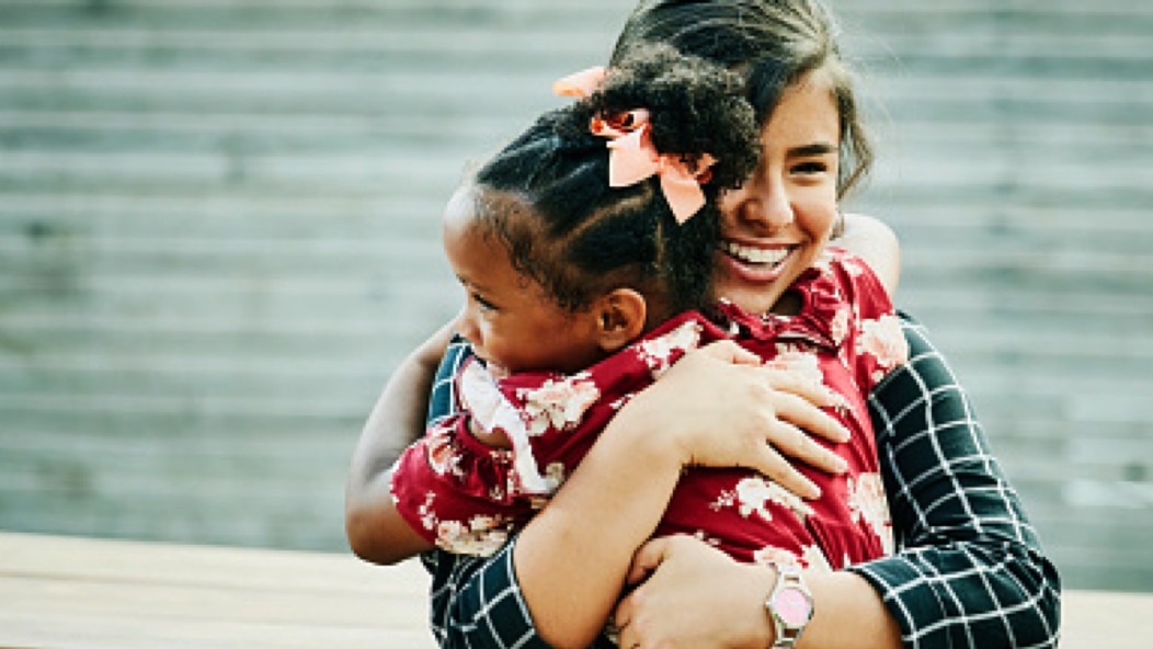 A woman hugging a child.